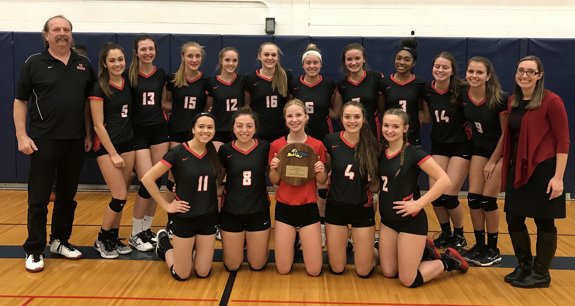 The Niagara-Wheatfield girls volleyball team poses with its Far West Regional plaque after defeating Irondequoit, 3-1. The win sends the Falcons to the state tournament for the first time in program history. (Photos by David Yarger)